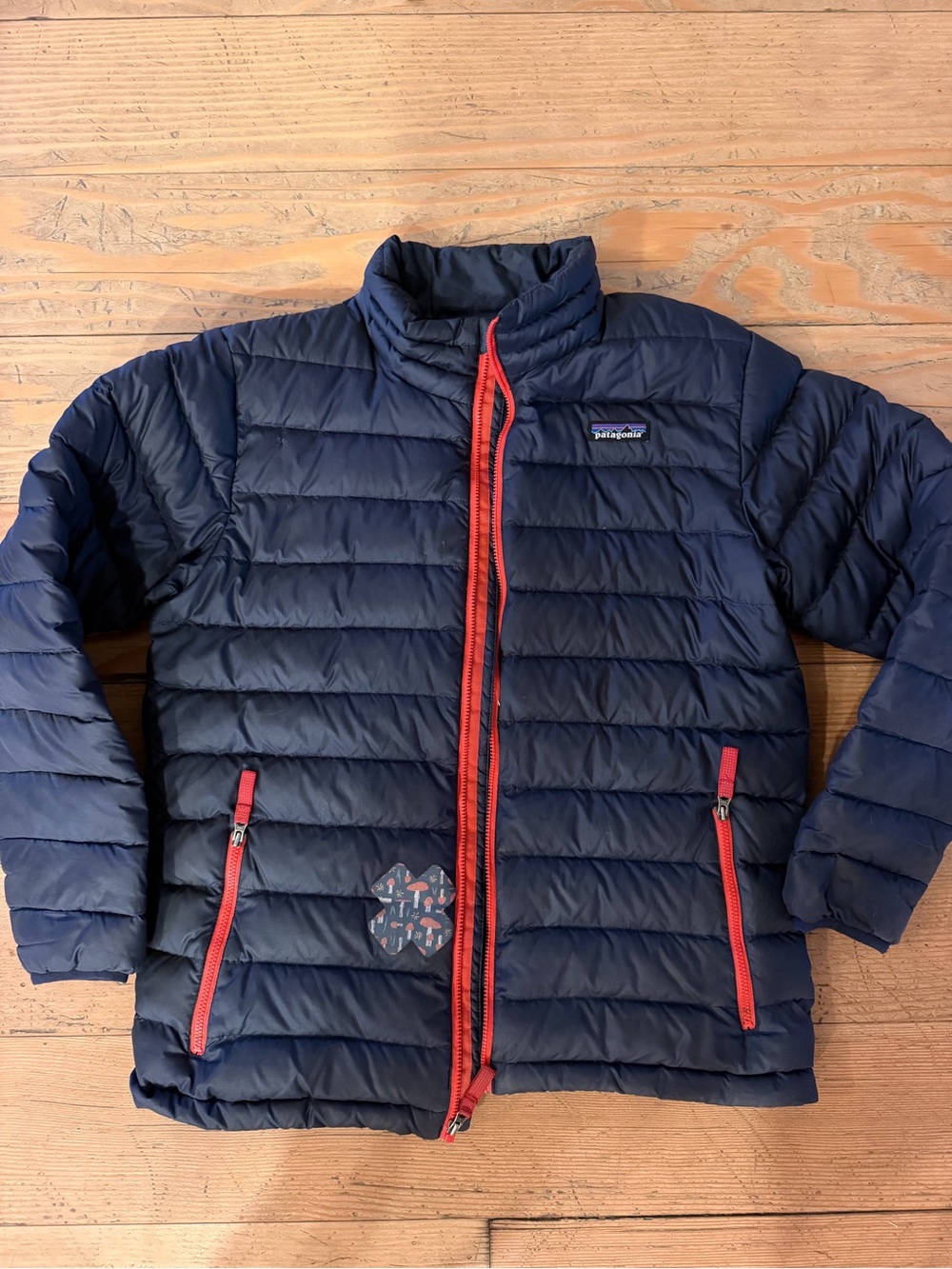 Patagonia Kids navy puffer jacket with red zippers
